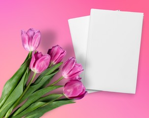Tulips and paper on the table.