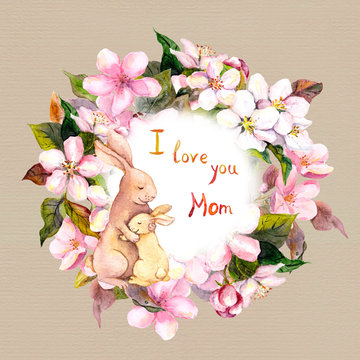 Mom rabbit embrace her child in apple flowers wreath. Greeting card for Mothers day. Watercolor