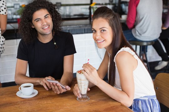 Portrait of smiling couple using mobile phone 