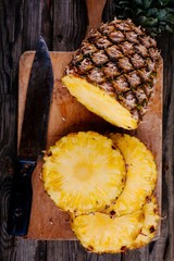 Fresh raw organic pineapple on a wooden background