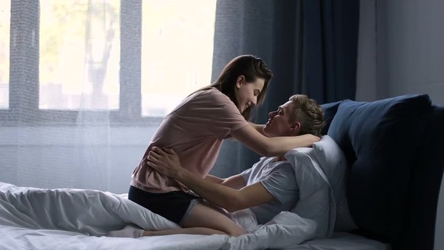 Romantic couple relaxing in bed in the morning