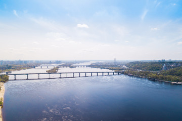Panoramic view of the city of Kiev in the spring. View of the Dnieper River and bridges across it. Aerial view, from above. Outdoor.