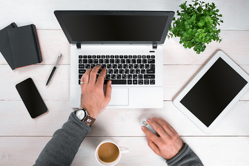 Directly above view of human hands typing on laptop.