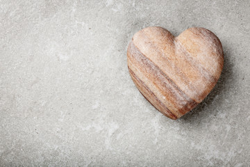 Stone heart on gray background