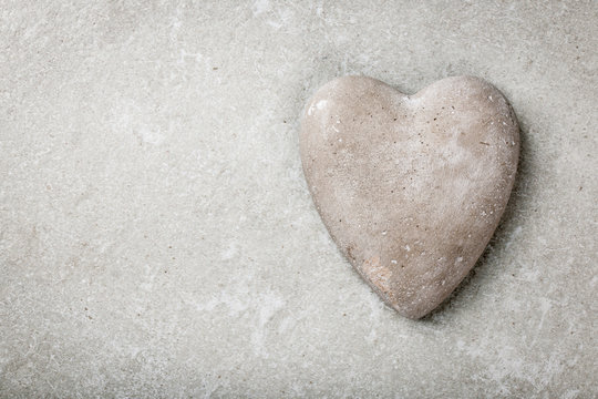 Stone heart on gray background