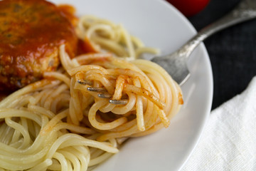Spaghetti pasta with meatballs, tomato sauce. on dark background with copy space