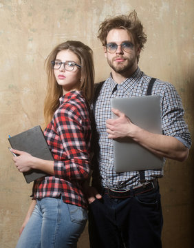 Young nerd couple of students in geek glasses