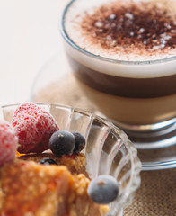 Sweet fruit dessert and cappuccino cup
