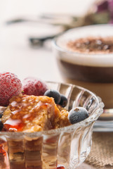 Sweet fruit dessert and cappuccino cup