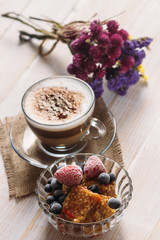 Sweet fruit dessert and cappuccino cup