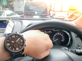 The Man looking watch with hand driving car on the traffic jam , digital effect sunlight