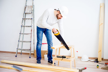 Carpenter with a handsaw