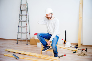 Builder with yellow tape measure