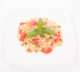 Risotto with tomato and pea on a white background