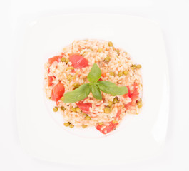 Risotto with tomato and pea on a white background