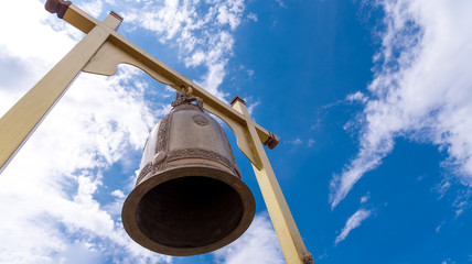 Bell hanging in a temple. Bell Brass bells hanging in the grayish sky background