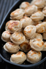 Fried russian meat dumplings pelmeni, close-up, selective focus, vertical shot