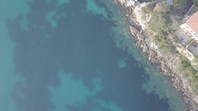 Flight over the mediterranean coastline on the border Italy France. Capo Mortola, Grimaldi (Ventimiglia), Italy, Europe. Aerial panoramic view 4K, UHD native log movie.