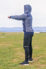 young man doing exercise in a park