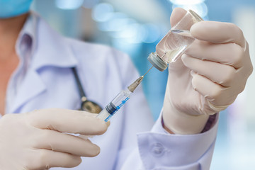 Doctor gaining in a syringe medication.