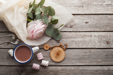 Pink ranunculus, headphones, hot chocolate