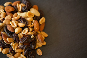 Various nuts on stone table. Top view.