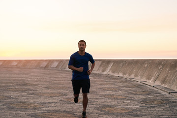 Fit young Asian man enjoying a solitary morning run