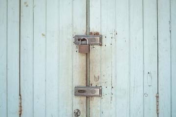 Locks on rusty wooden door.Nobody's home concept.