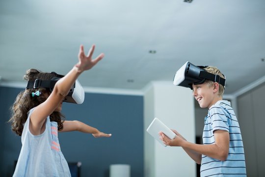 Siblings using virtual reality headset