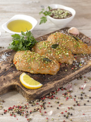 Chicken fillet in marinade on a wooden board. 