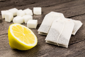 tea bags,sugar and lemon on the wooden table