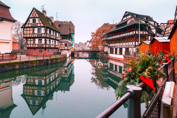 Traditional Alsatian half-timbered houses in Petite France with mirror reflections in the morning, Strasbourg, Alsace, France - obrazy, fototapety, plakaty