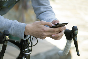 young man with the mobile phone and the bike