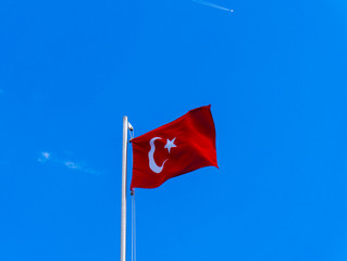 turkish flag waving in blue sky