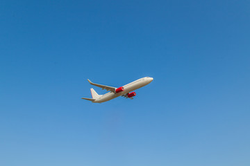 Naklejka na ściany i meble Airplane with beautiful sky on background.