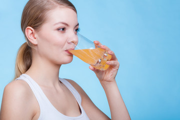 Woman drinking orange flavored drink or juice