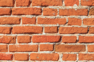 Old brickwork with broken bricks on lime mortar