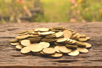pile of gold coin on the wooden background  financial and saving concept.
