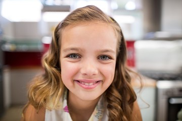 Girl smiling at camera at home