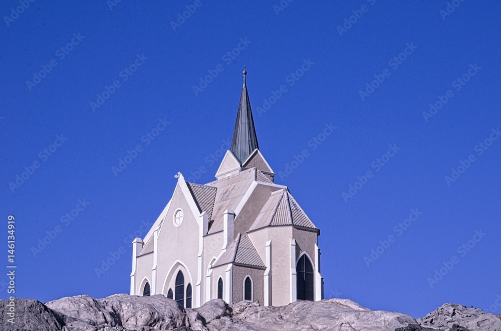 Wall mural church on the hill with blue sky background