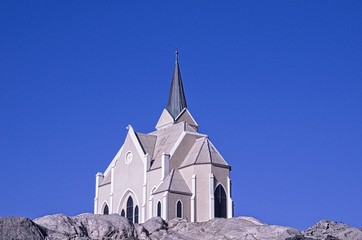 Fototapeta na wymiar Church on the hill with blue sky background
