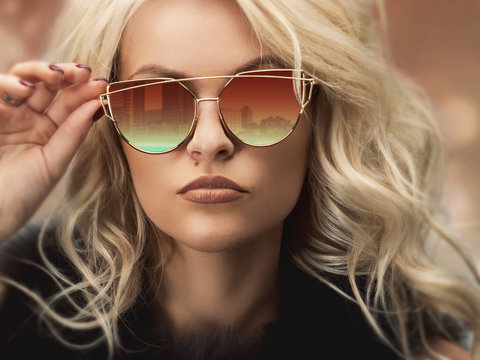 Portrait of a beautiful young blond woman in sunglasses. Photo closeup