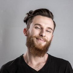 Obraz premium Joyful, happy young man isolated on gray backround