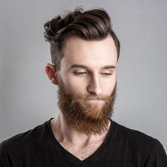 Obraz premium Sad and unhappy young man isolated on gray backround