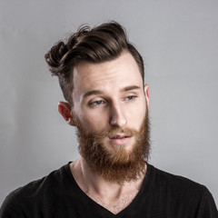 Obraz premium Sad and unhappy young man isolated on gray backround