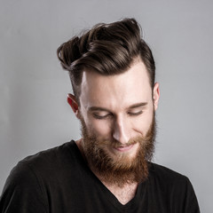 Shy young man isolated on gray backround