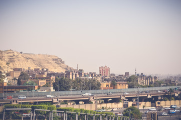 Fototapeta premium view of mountain with cars on road at cairo, egypt