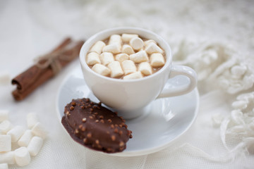 one white mug on a white background with marshmallow