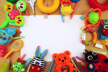 Fototapeta na wymiar Children's toys and accessorieson a wooden background