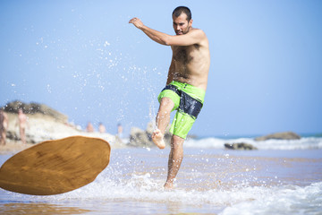 Skimboarder in beach